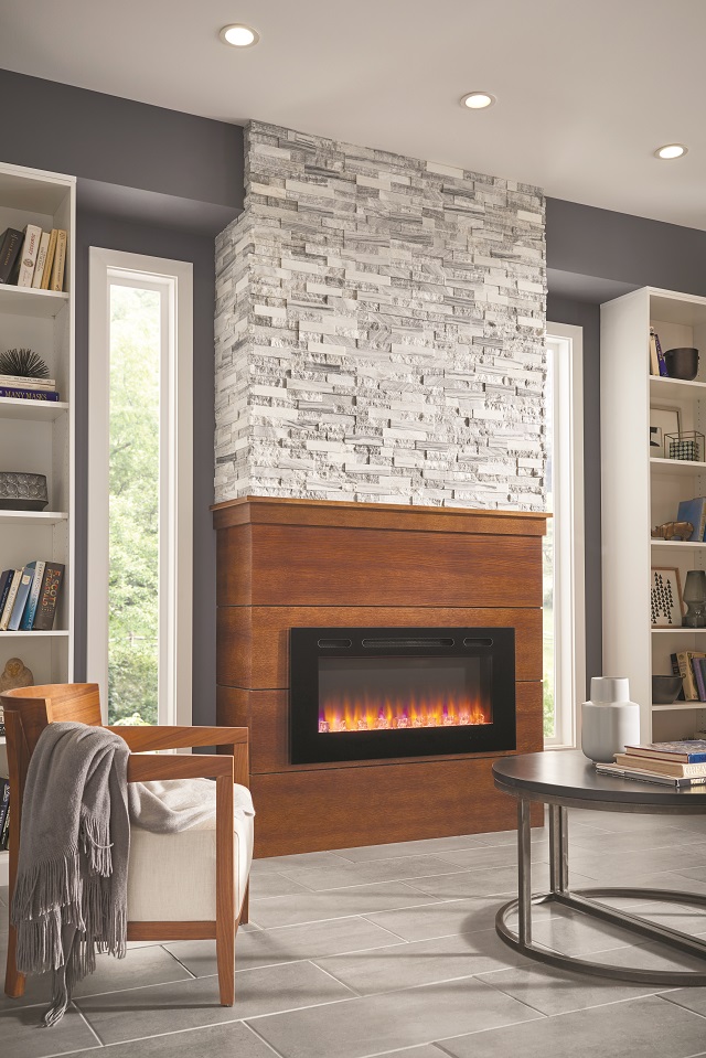 Gray tiled fireplace in modern styled living room with recessed lighting 